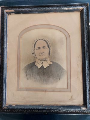 Framed portrait sketch of a woman in a dark high-necked dress with white collar and lace cap, companion piece to...