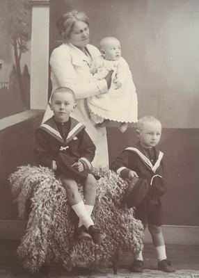 Anna Margaretha Marincowitz, born Oosthuizen, with her three sons in a photographer's studio against a painted...