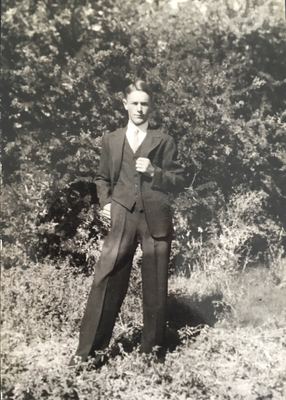 GERT ANNIS "TOKKIE" OOSTHUIZEN MARINCOWITZ (1919-2003) as a young man, in a three-piece suit and a patterned tie,...