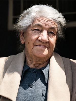 Johanna Fredricka Oosthuizen, born Malherbe (1875-1959), in old age: white hair loose in the wind, deep lines, a...