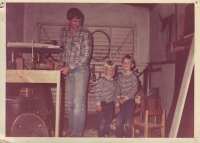 Christiaan Johannes Joubert Oosthuizen at a DeWALT radial-arm saw in his workshop, one hand on a bench he is...