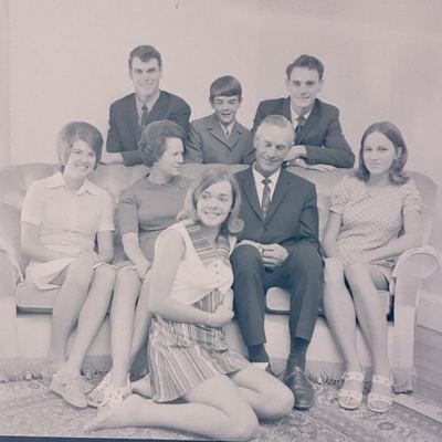 A family group on a sofa, all eight of the household. MARIA MAGRITHA "MARIE" VAN DER MERWE sits at the left, then...