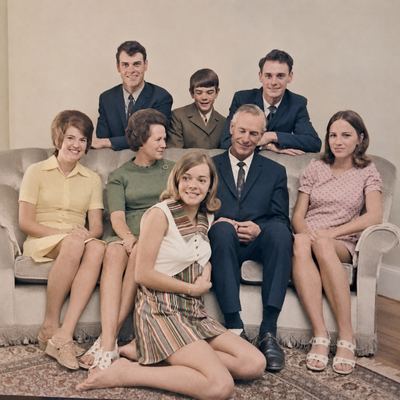 A family group on a sofa, all eight of the household. MARIA MAGRITHA "MARIE" VAN DER MERWE sits at the left, then...