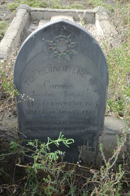 The headstone of Cornelis Jacobus Botma (1867-1910) in the same plot, a standing dark stone with a carved sunburst...