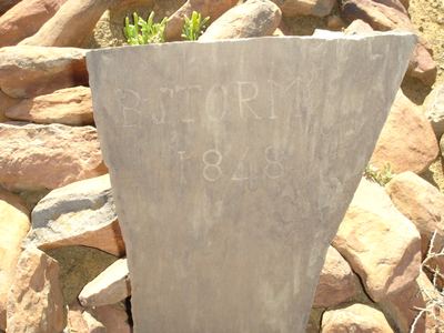 A slate slab set in a stone kerb, scratched B. STORM 1848 and nothing else. The oldest date on any grave in this project.