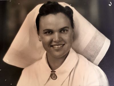 Frances Duminy “Babie” Joubert (1918-1965) in nurse’s uniform - white dress, starched veil and a medal or badge at...