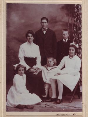 Johanna Fredricka Oosthuizen, born Malherbe (1875-1959), seated with her five children in a photographer's studio...
