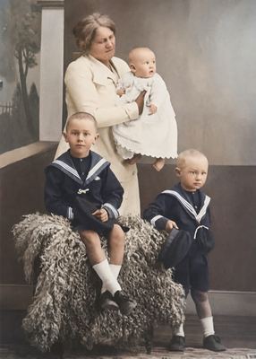 Anna Margaretha Marincowitz, born Oosthuizen, with her three sons in a photographer's studio against a painted...