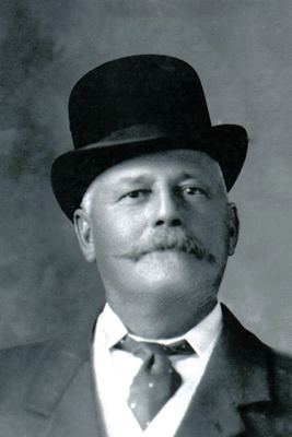 Frederik Simon Oosthuizen (1856-1936) in a bowler hat, a heavy moustache turned up at the ends, wing collar and...