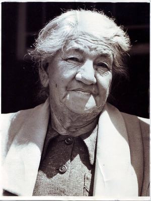 Johanna Fredricka Oosthuizen, born Malherbe (1875-1959), in old age: white hair loose in the wind, deep lines, a...