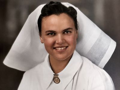 Frances Duminy “Babie” Joubert (1918-1965) in nurse’s uniform - white dress, starched veil and a medal or badge at...