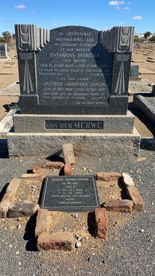 A polished granite headstone in a walled kerb marked VAN DER MERWE, with a small plaque set in brick on the ground...